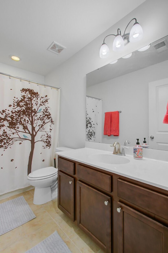 bathroom with tile patterned flooring, vanity, visible vents, and toilet