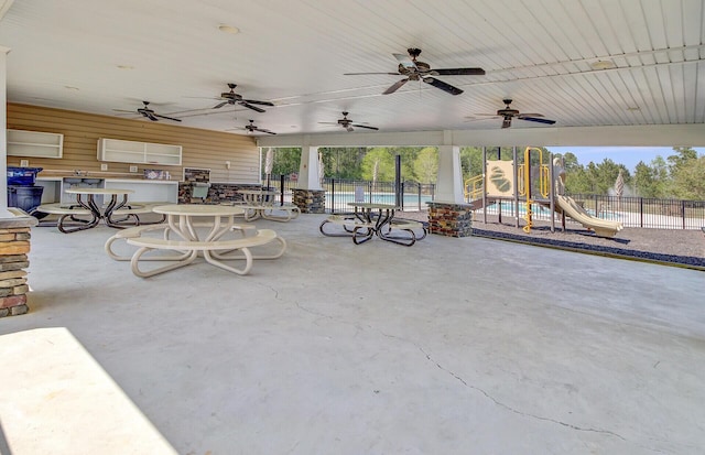 view of patio / terrace with fence and playground community
