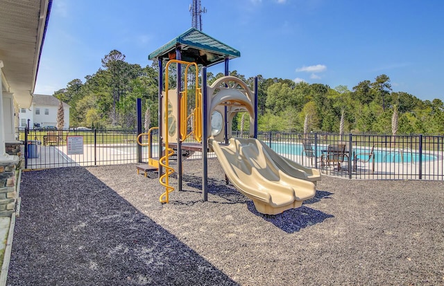 community play area with a community pool and fence