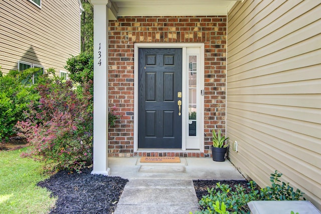 property entrance with brick siding