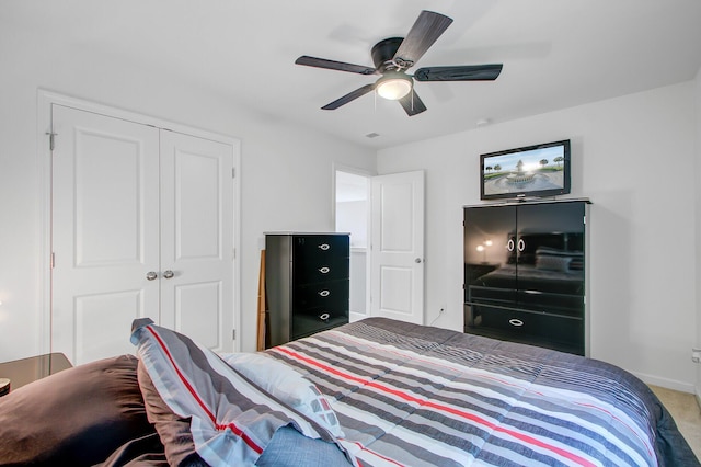 bedroom featuring a closet, baseboards, a ceiling fan, and carpet