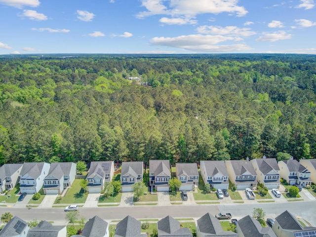 birds eye view of property featuring a forest view and a residential view