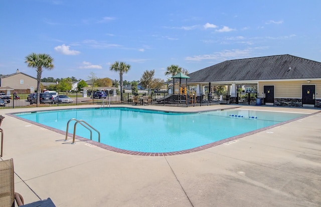community pool featuring a patio area and fence