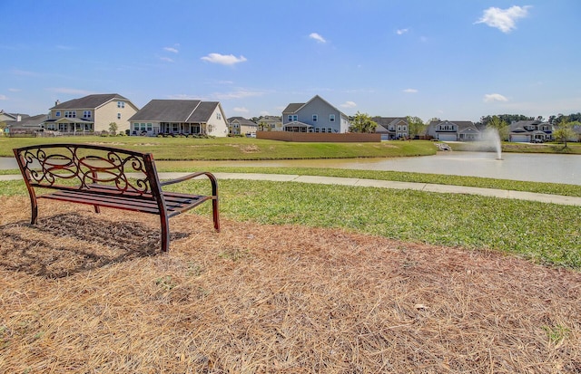 view of yard featuring a water view and a residential view