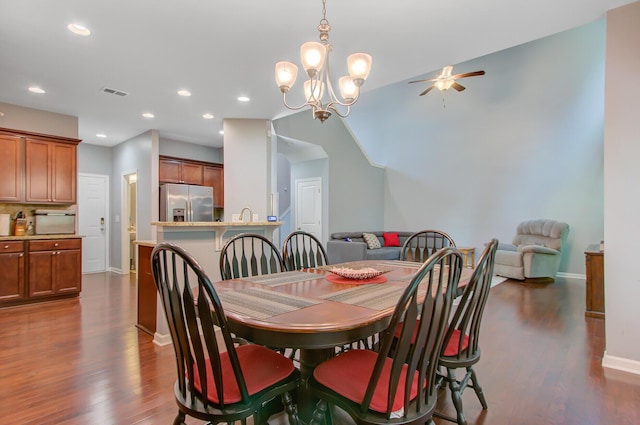 dining room with ceiling fan with notable chandelier, visible vents, recessed lighting, dark wood-style flooring, and baseboards
