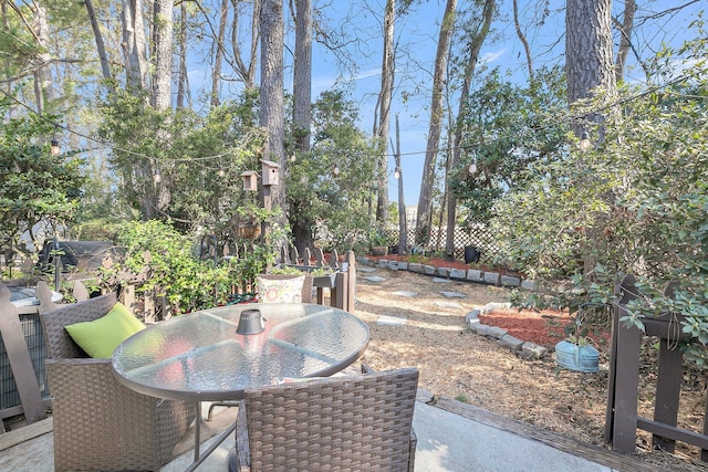 view of patio with outdoor dining space and fence