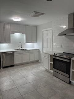 4324 Purdue Dr, North Charleston, SC 29418 - kitchen with stainless steel appliances, wall chimney exhaust hood, a sink, and light countertops
