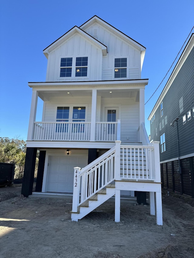 coastal home with a garage and covered porch