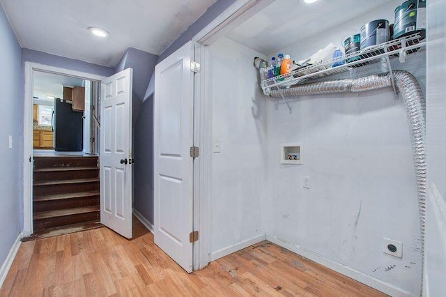 laundry area featuring hookup for a washing machine, electric dryer hookup, and light hardwood / wood-style floors