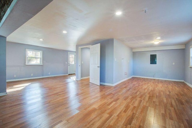 unfurnished room featuring electric panel and light hardwood / wood-style flooring