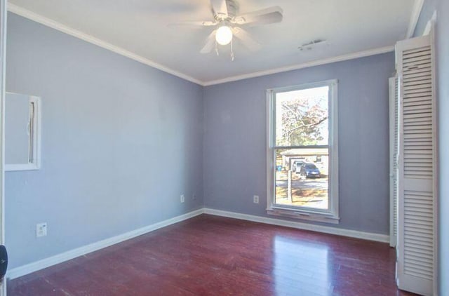 unfurnished bedroom with dark hardwood / wood-style flooring, crown molding, and ceiling fan