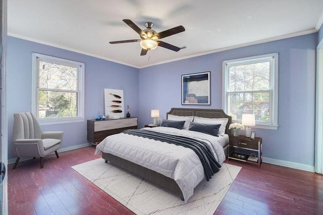 bedroom featuring dark wood-type flooring, ceiling fan, and ornamental molding