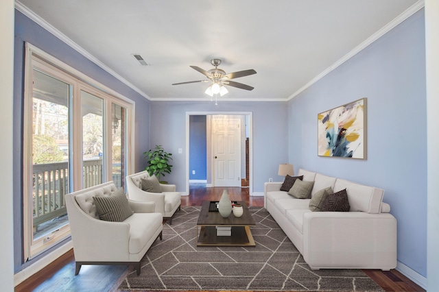 living room with dark hardwood / wood-style flooring, crown molding, and ceiling fan