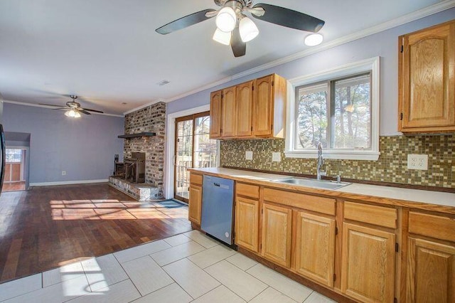 kitchen featuring tasteful backsplash, stainless steel dishwasher, ornamental molding, and sink