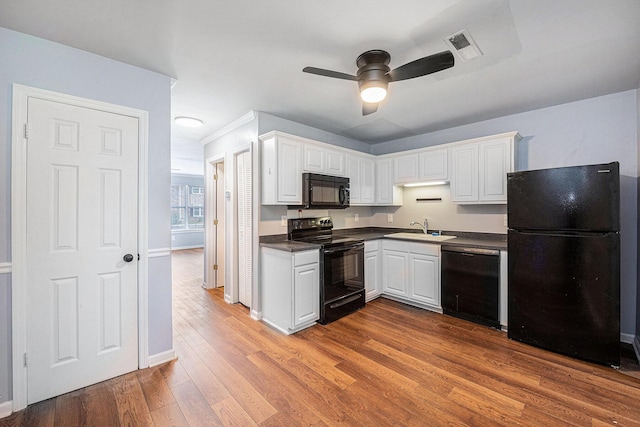 2045 Rondo St Unit B, Charleston, SC 29414 - kitchen with black appliances, dark countertops, a ceiling fan, white cabinetry, and wood finished floors