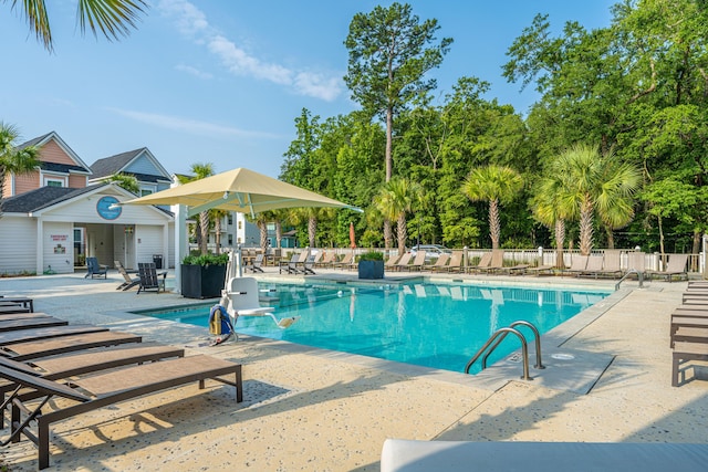 pool featuring a patio area and fence