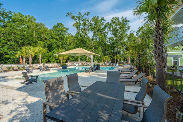 view of patio with fence and a community pool