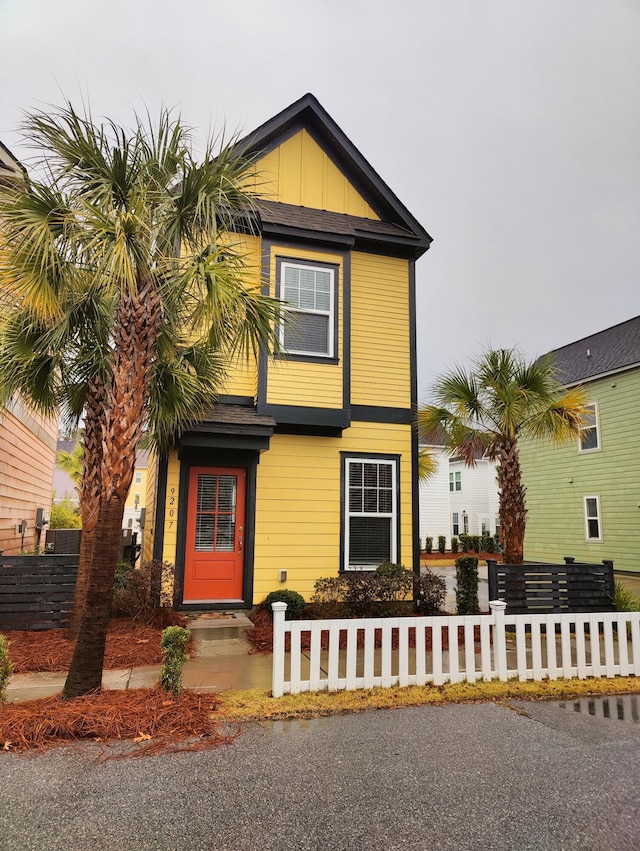 view of front facade featuring board and batten siding and fence