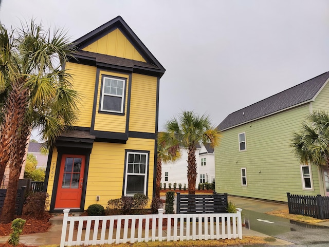 view of front of house featuring board and batten siding and a fenced front yard