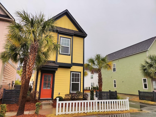 view of front of home with a fenced front yard and board and batten siding