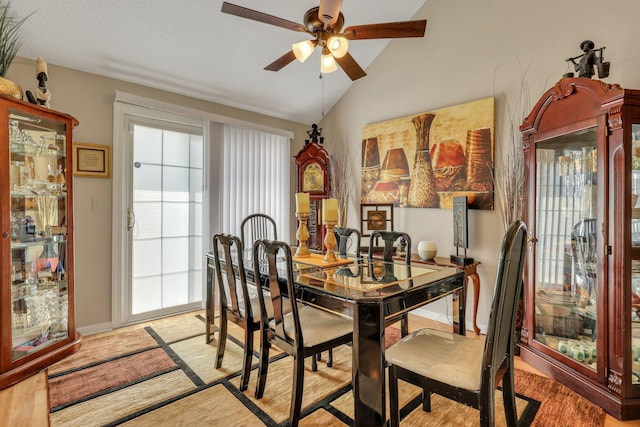 dining room featuring ceiling fan, lofted ceiling, and light wood-type flooring