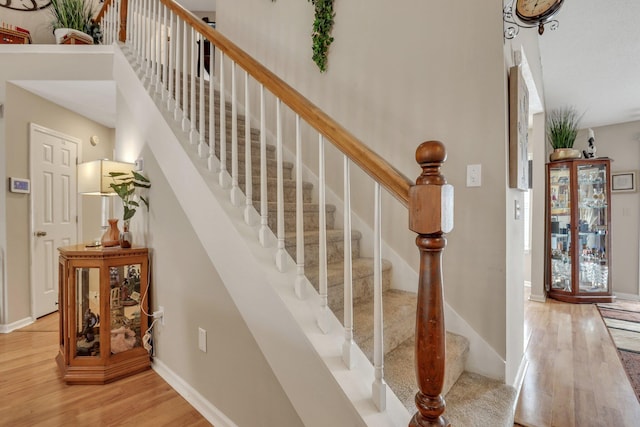 stairs featuring hardwood / wood-style flooring