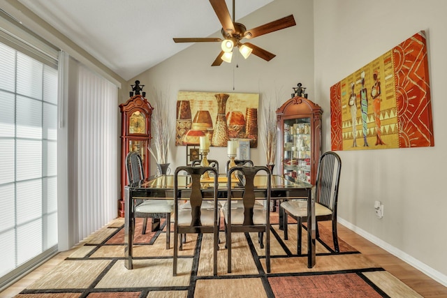 dining area with light hardwood / wood-style flooring, vaulted ceiling, ceiling fan, and plenty of natural light