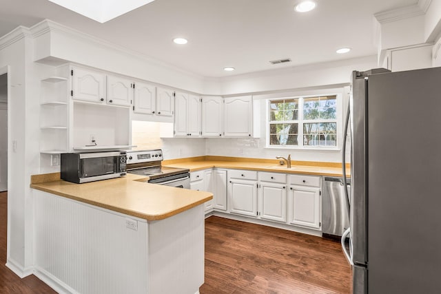 kitchen with open shelves, stainless steel appliances, dark wood-type flooring, white cabinetry, and a peninsula