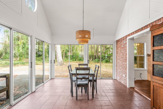 sunroom featuring vaulted ceiling