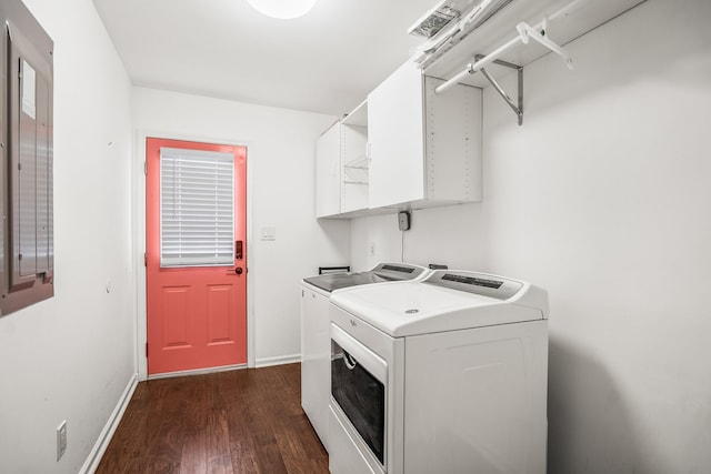 laundry area with dark wood-style floors, washer and dryer, laundry area, and baseboards