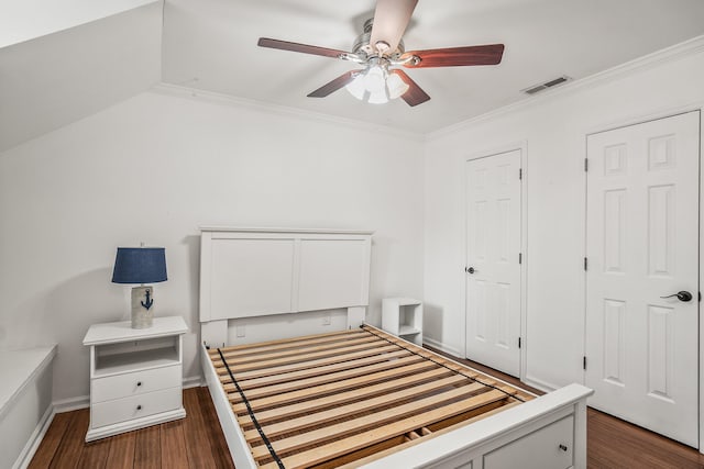 bedroom with crown molding, dark wood finished floors, visible vents, a ceiling fan, and baseboards