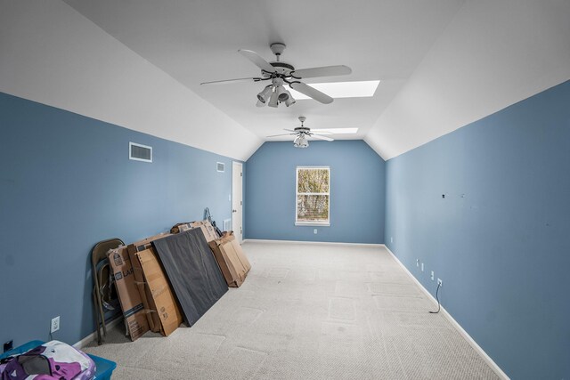 additional living space with lofted ceiling with skylight, baseboards, visible vents, and carpet flooring