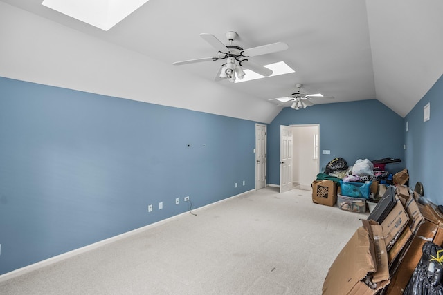 additional living space with vaulted ceiling with skylight, carpet, baseboards, and a ceiling fan