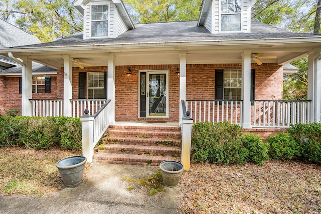 view of front of home featuring a shingled roof, covered porch, and brick siding