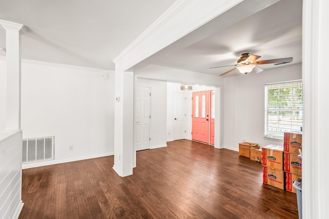 spare room with a ceiling fan, visible vents, wood finished floors, and ornamental molding