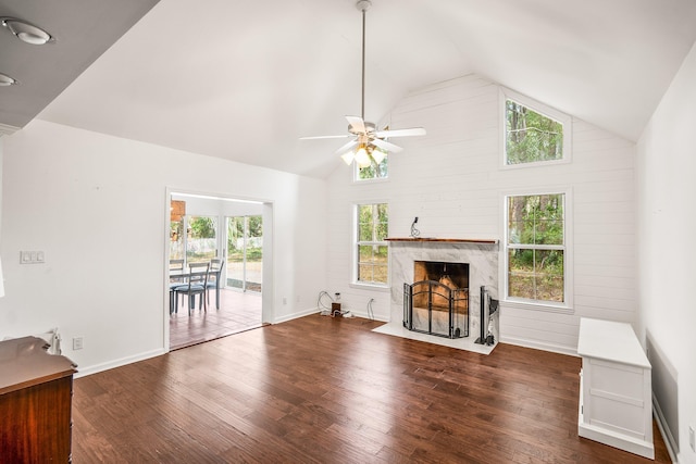 unfurnished living room with ceiling fan, a fireplace, high vaulted ceiling, and wood finished floors