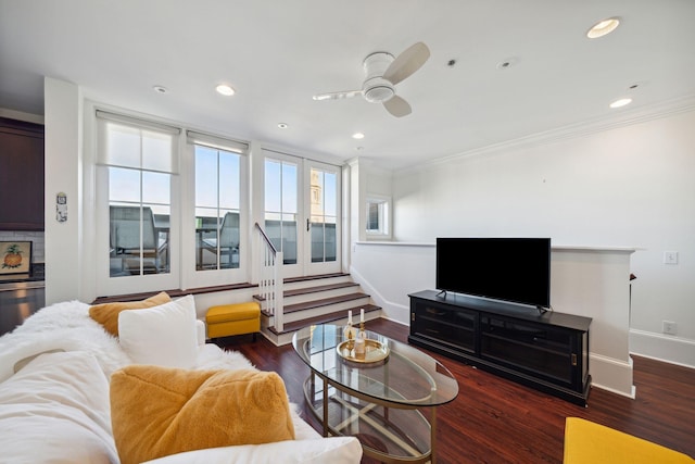 living room featuring ornamental molding, ceiling fan, and dark wood-type flooring