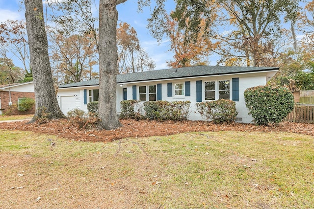 ranch-style home with a garage and a front lawn