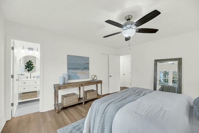 bedroom with ensuite bathroom, ceiling fan, and wood-type flooring