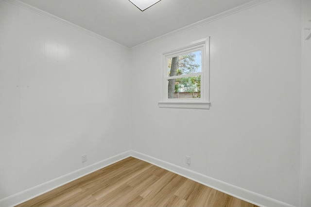 spare room with wood-type flooring and crown molding