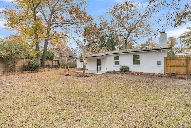 back of property with a patio