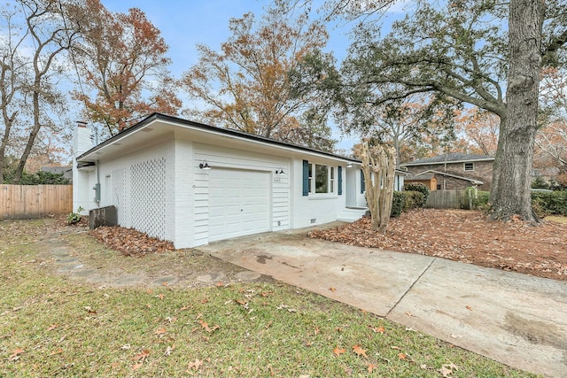 view of front of property with central air condition unit and a garage