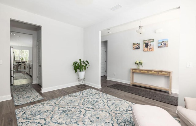 interior space featuring visible vents, baseboards, and wood finished floors