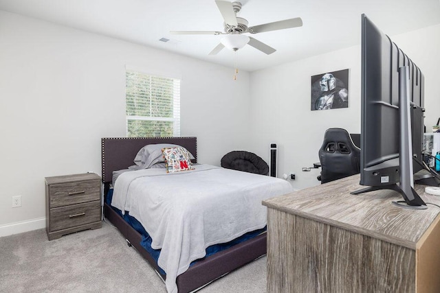 bedroom featuring light colored carpet, baseboards, a ceiling fan, and visible vents