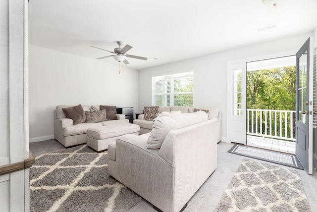 living room featuring ceiling fan and baseboards