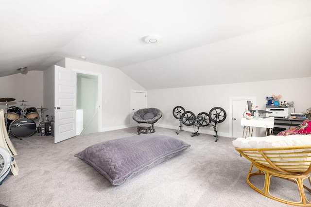 bedroom featuring baseboards, lofted ceiling, and carpet