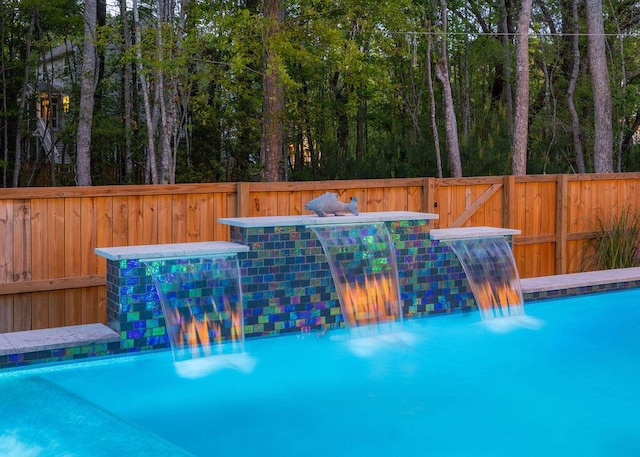 view of swimming pool with fence