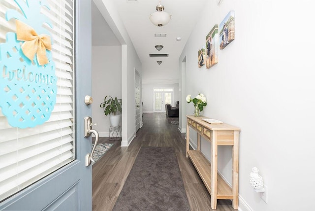 hall featuring baseboards and wood finished floors