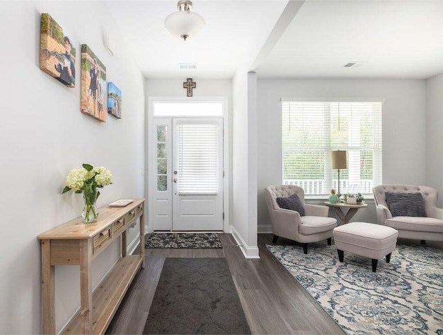entryway with dark wood-style flooring, baseboards, and visible vents