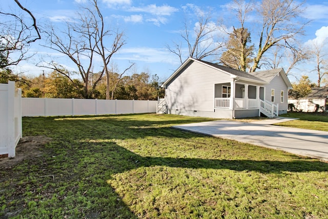 exterior space featuring a lawn and covered porch